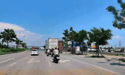 Xe máy lao vào đuôi container vì luồn lách